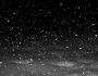 Snow falling through the night