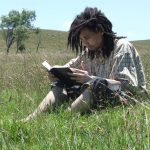 reading-the-bible Man reading his Bible in a field