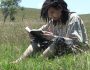 Man reading his Bible in a field