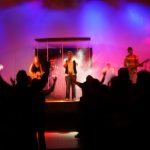 A group of teens worshiping God